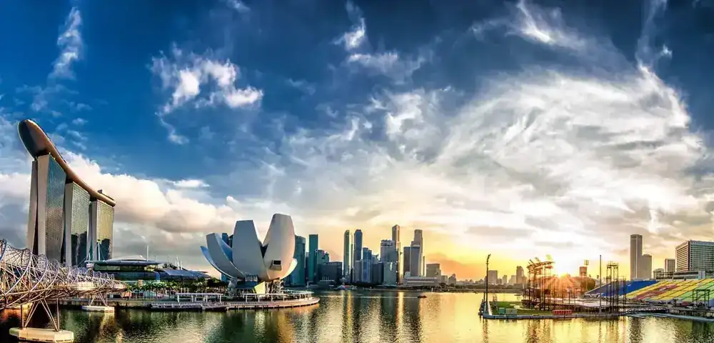 Marina Bay at dawn with the city skyline reflected in still water