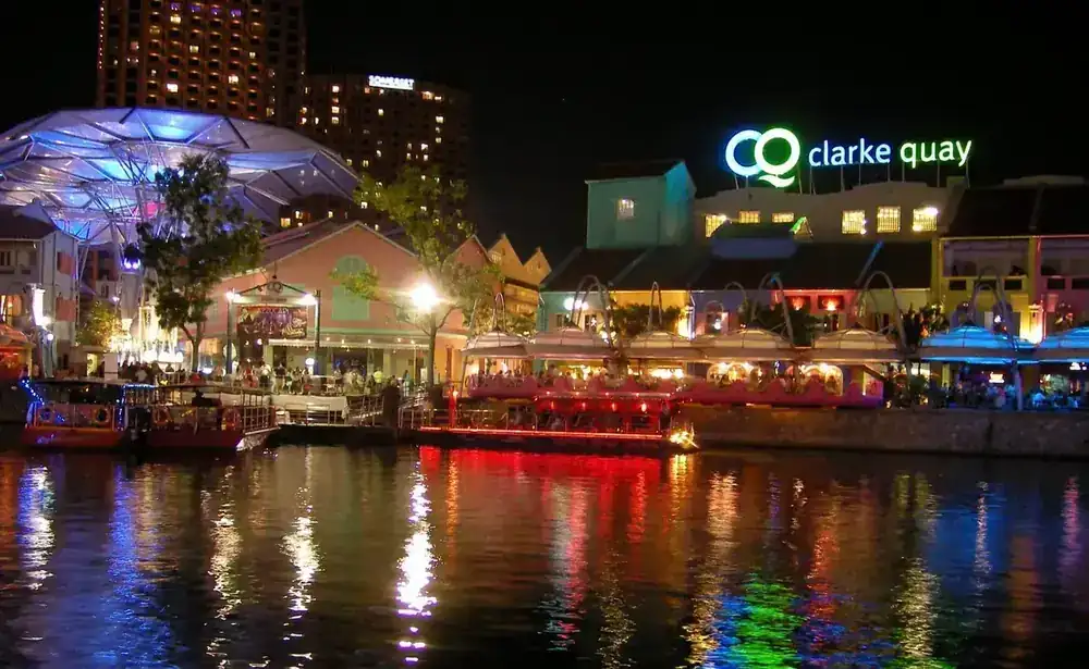 Clarke Quay shophouses illuminated at night along the Singapore River